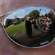 President Donald Trump on the South Lawn of the White House in October 2018, as seen reflected in the sunglasses of a Secret Service agent.